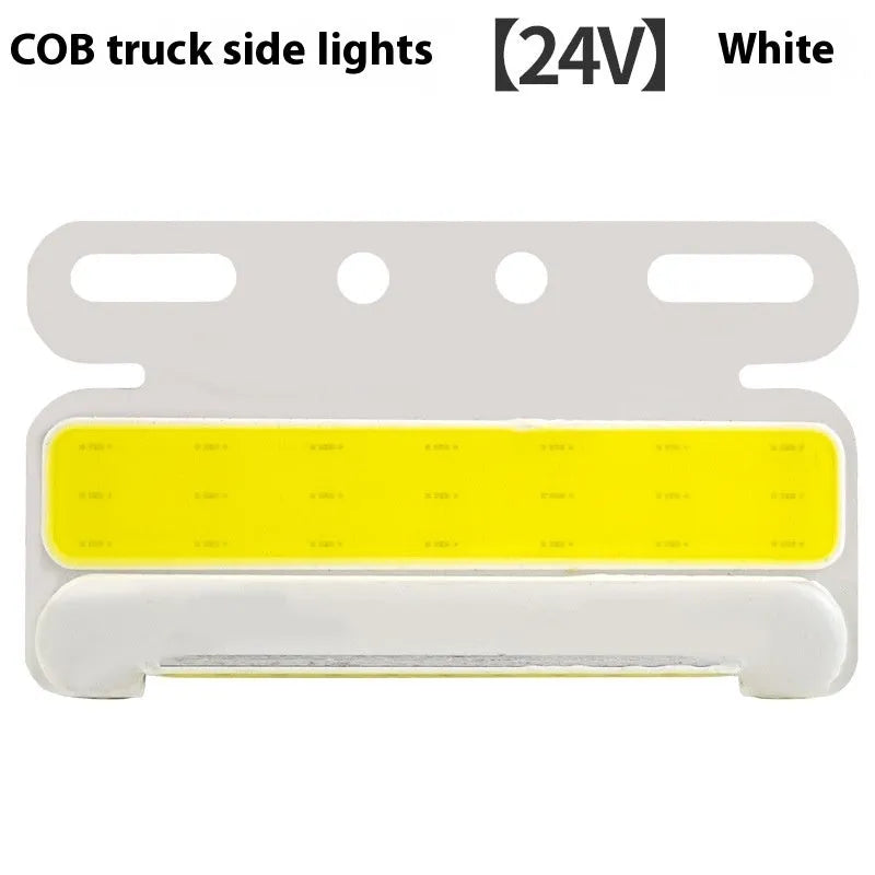 Aluminium alloy COB LED truck side light projecting bright white light onto ground next to tyre.