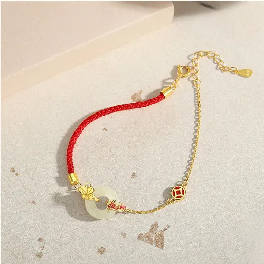 Gold-colour Koi fish charm bracelet in 925 silver with a red rope and peace buckle safety clasp.