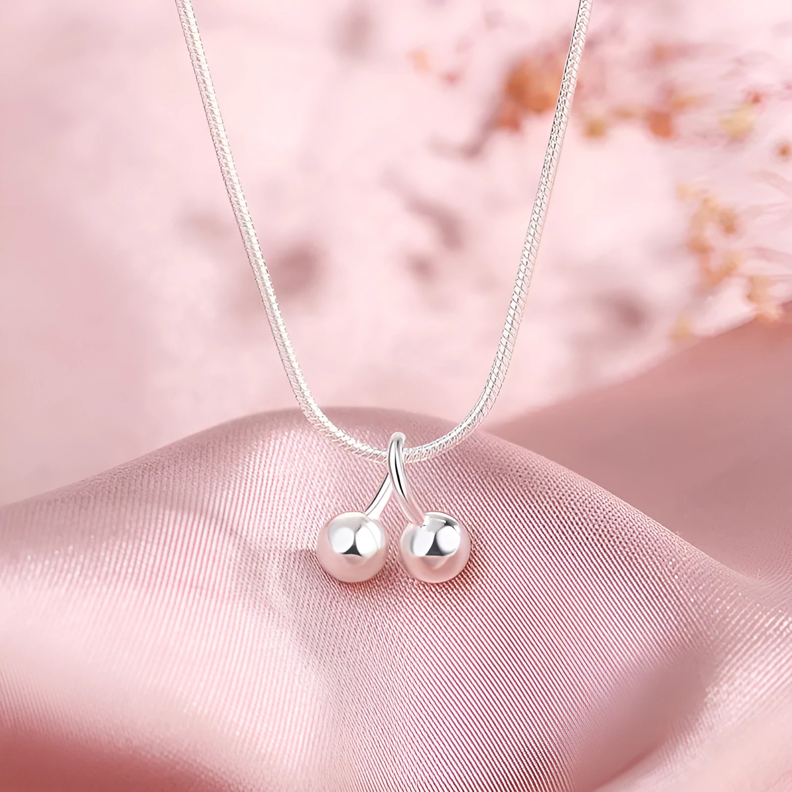 Silver cherry necklace for women on a snake bone chain, adjustable length.