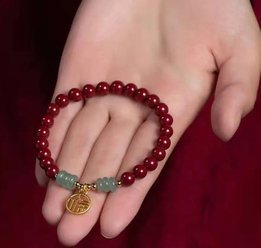 Handmade gold cinnabar wave bracelet showing genuine stone and copper bead construction in national style design