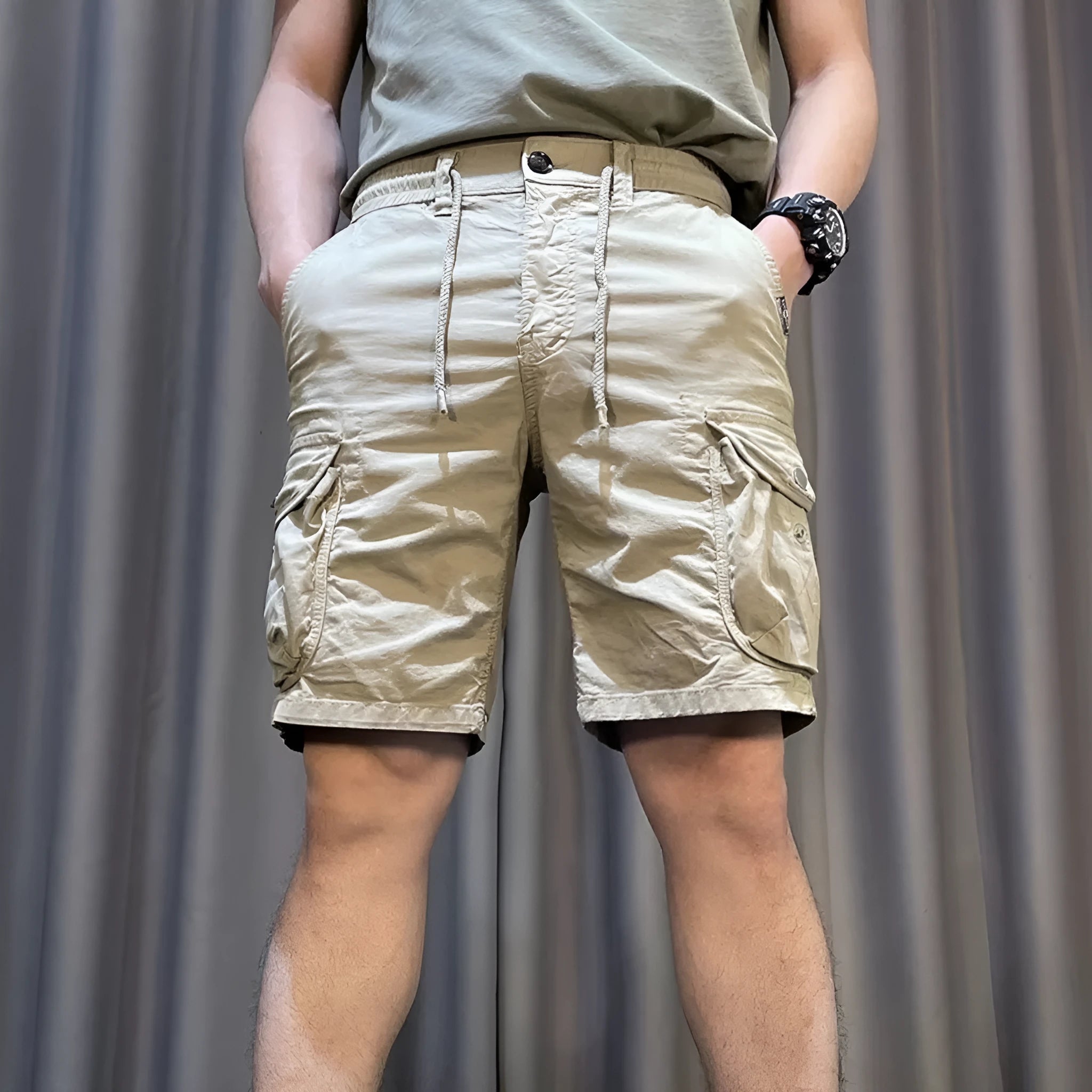 Loose straight-leg casual overalls with multiple cargo pockets in khaki, showing elastic waist and cropped length.