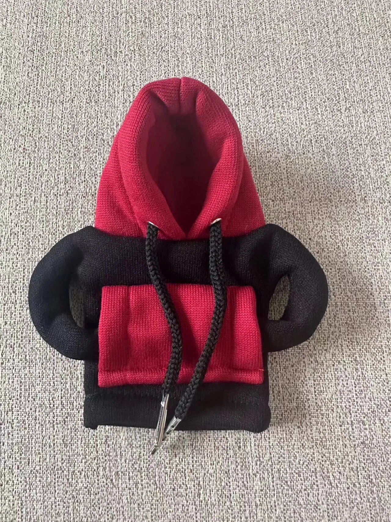 Red and white polyester car gear lever hood cover on a black gear stick.