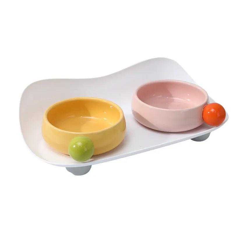 Ceramic raised double bowl set for pet food and water with a non-slip base in yellow.