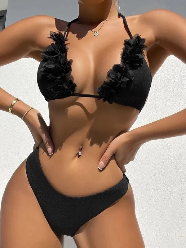 Black women's two-piece swimsuit set with gathered design, featuring a top and shorts.