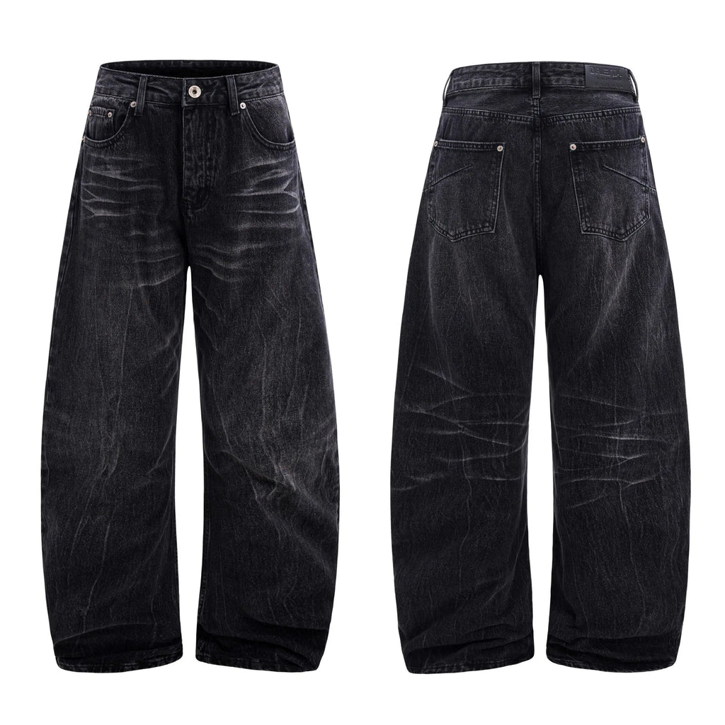 Men's black American washed straight leg jeans with old lightning crack detailing on a plain background
