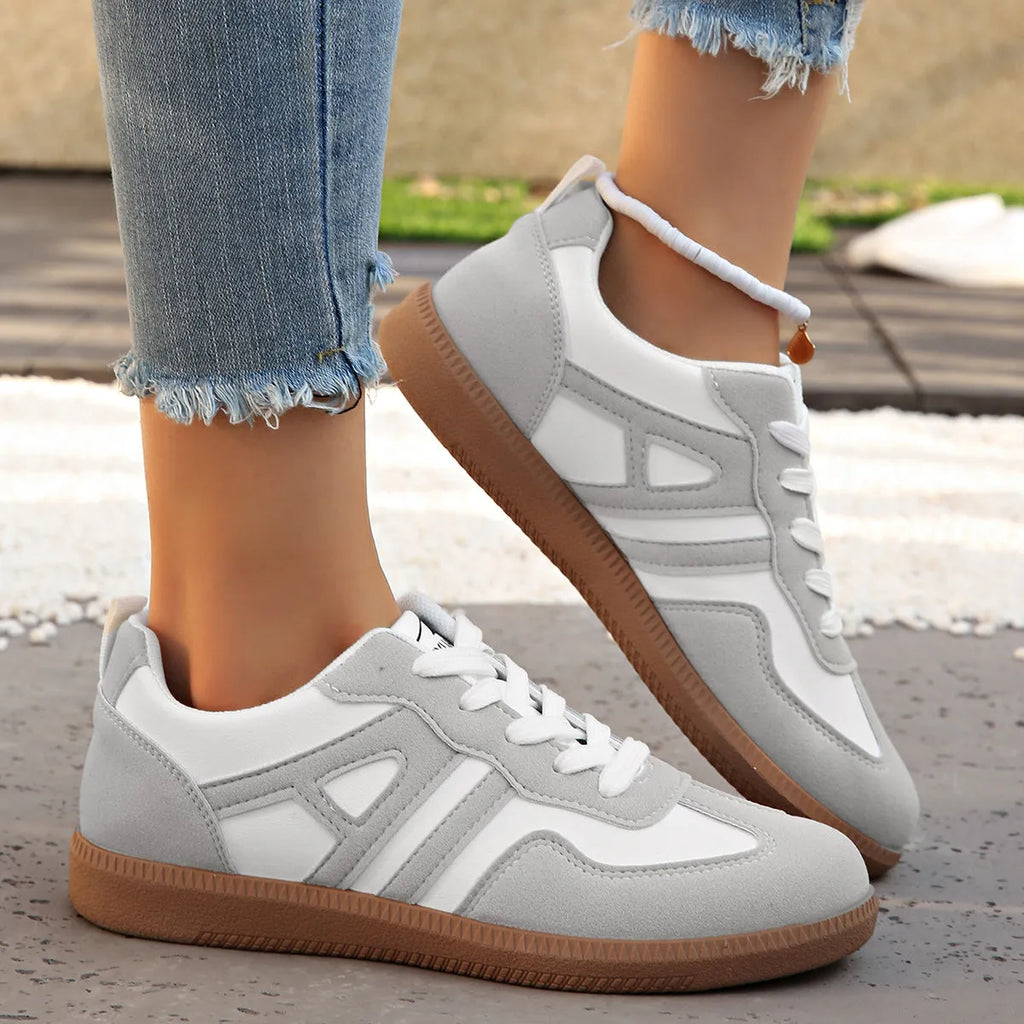 Retro lace-up women's jogging shoes in grey with a platform heel and cross strap detail.