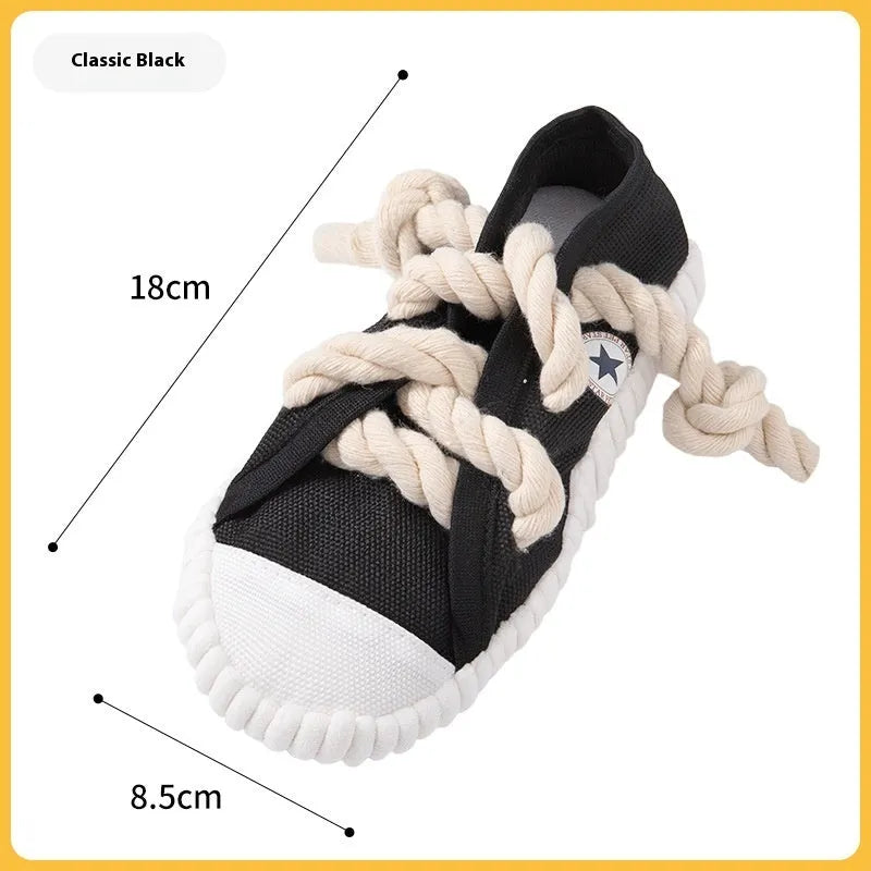 Yellow plastic dog slippers chew toy with a squeaker on a white background.