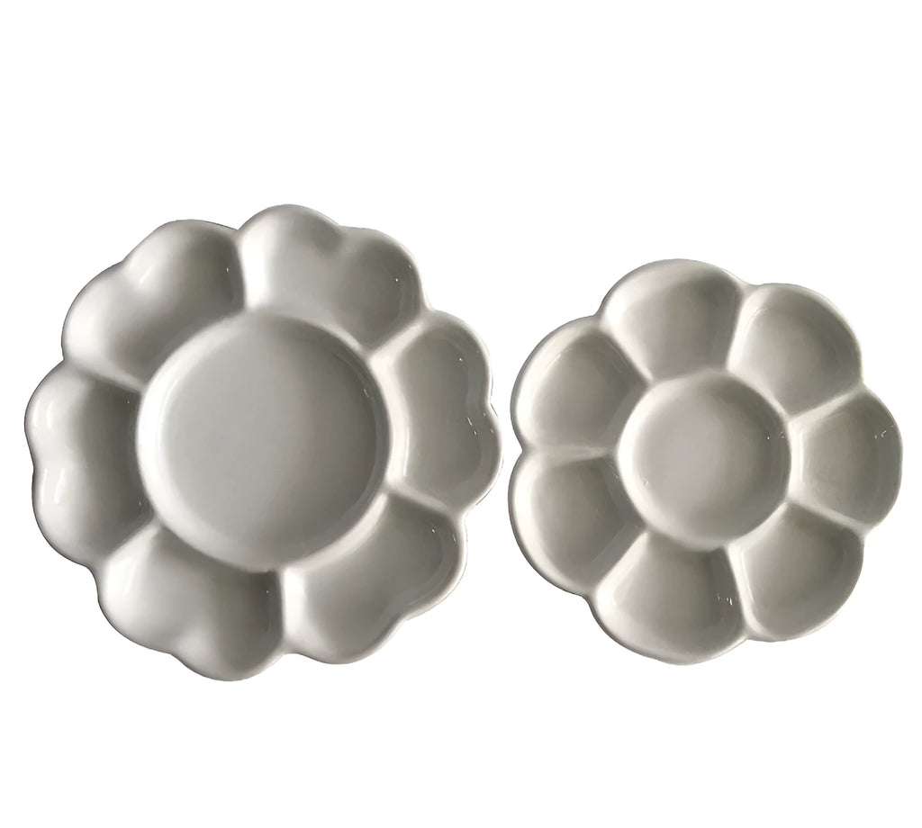 White hand-made ceramic plum blossom shaped artist palette for paint mixing.