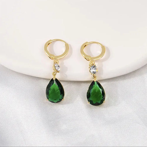 A pair of emerald green geometric teardrop alloy earrings on a plain background.