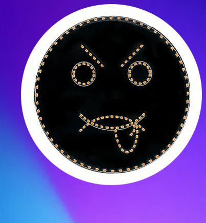 Black car rear window LED expression light showing smiley face design with orange illumination