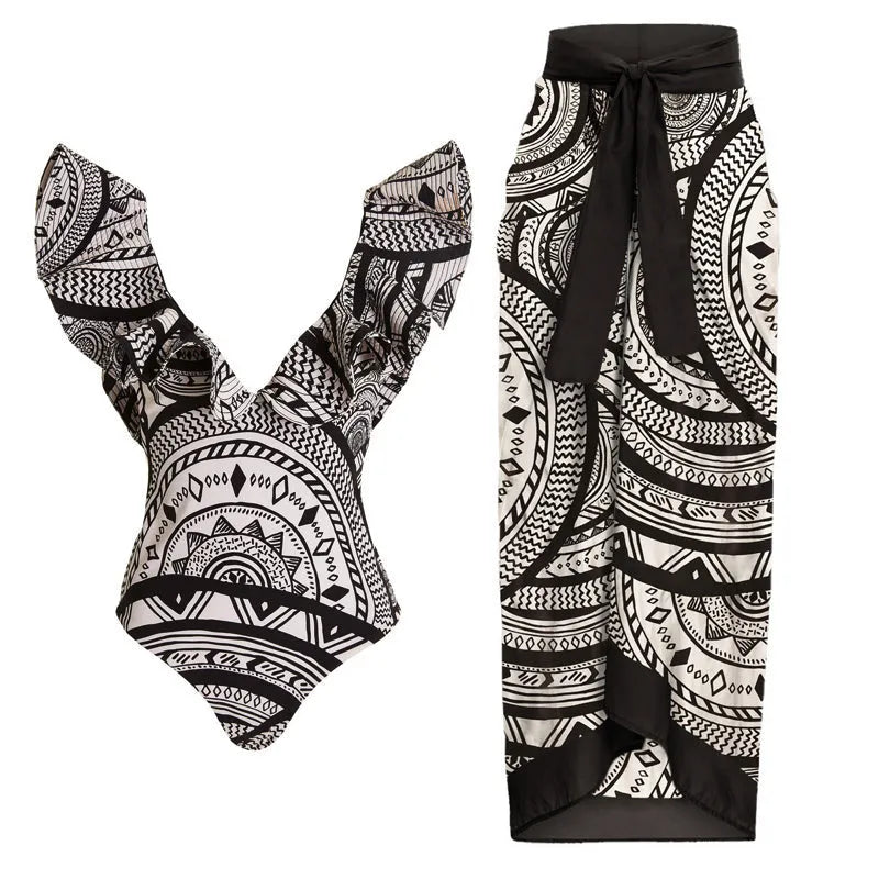 Women's vintage printed deep V-neck one-piece swimsuit with a matching wrap skirt laid flat.