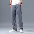 Man wearing light blue loose-fit straight-leg lyocell jeans with a zip fly