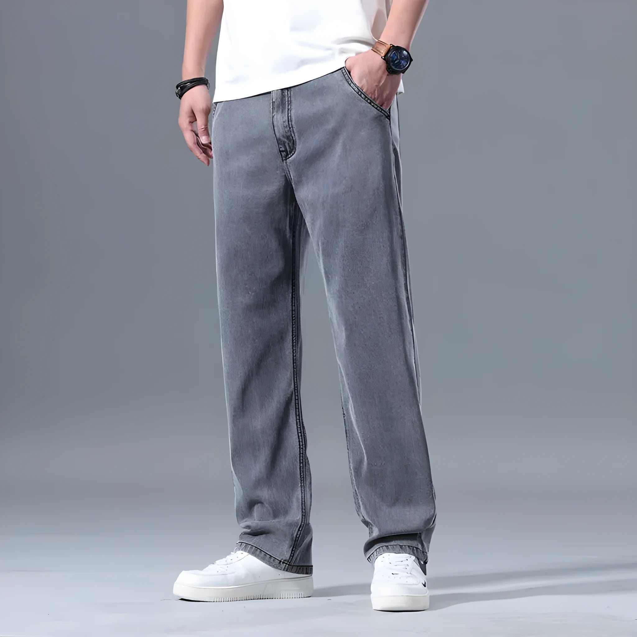 Man wearing light blue loose-fit straight-leg lyocell jeans with a zip fly