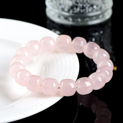 Pink bamboo crystal barrel bead bracelet with 11-12mm beads on a wrist.