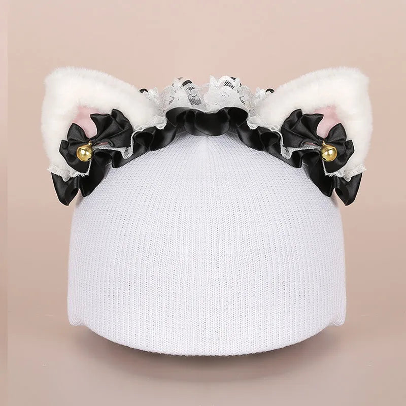 Soft plush cartoon-style decoration sitting on a ski helmet.