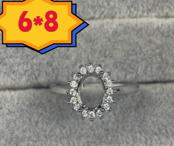 Oval denier fashion ring with open mouth setting, five-pointed star, and 6x8mm stone on copper band.
