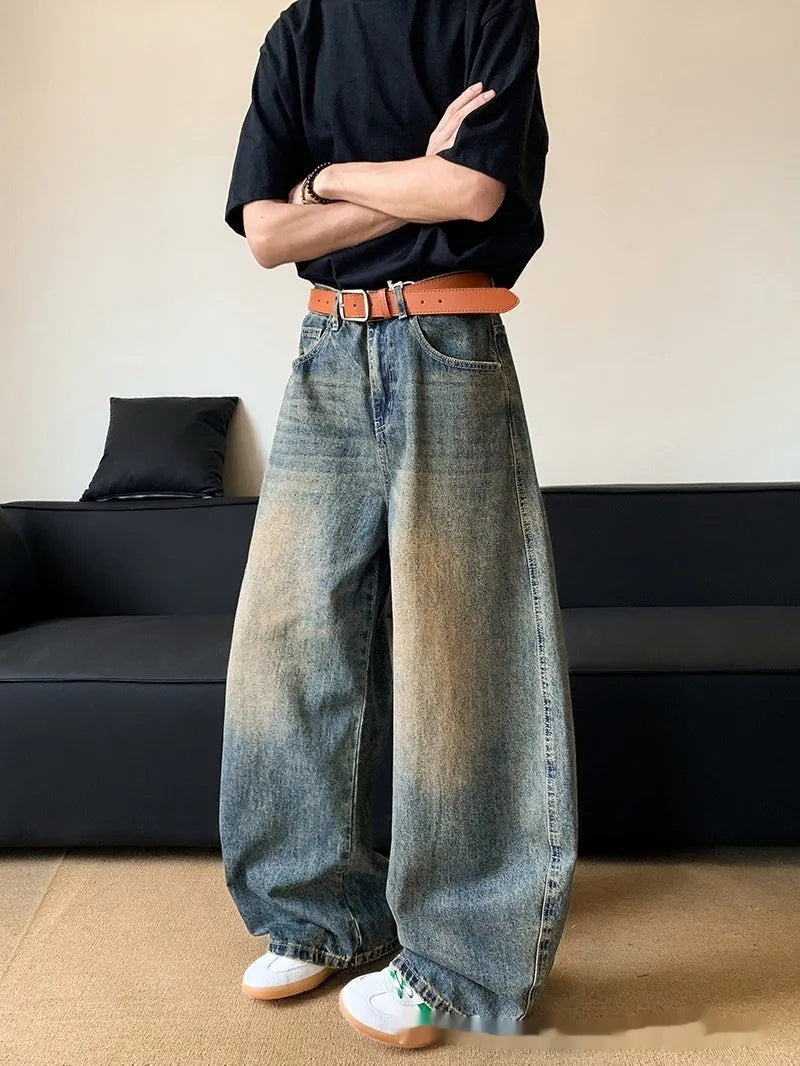 Man wearing Retro Blue distressed wide-leg denim jeans with a slimming silhouette and mid-waist fit.