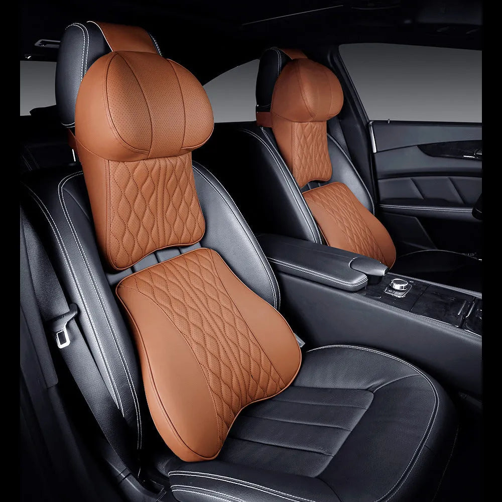 Beige and black car neck pillow and matching lumbar support pillow with wavy pattern.