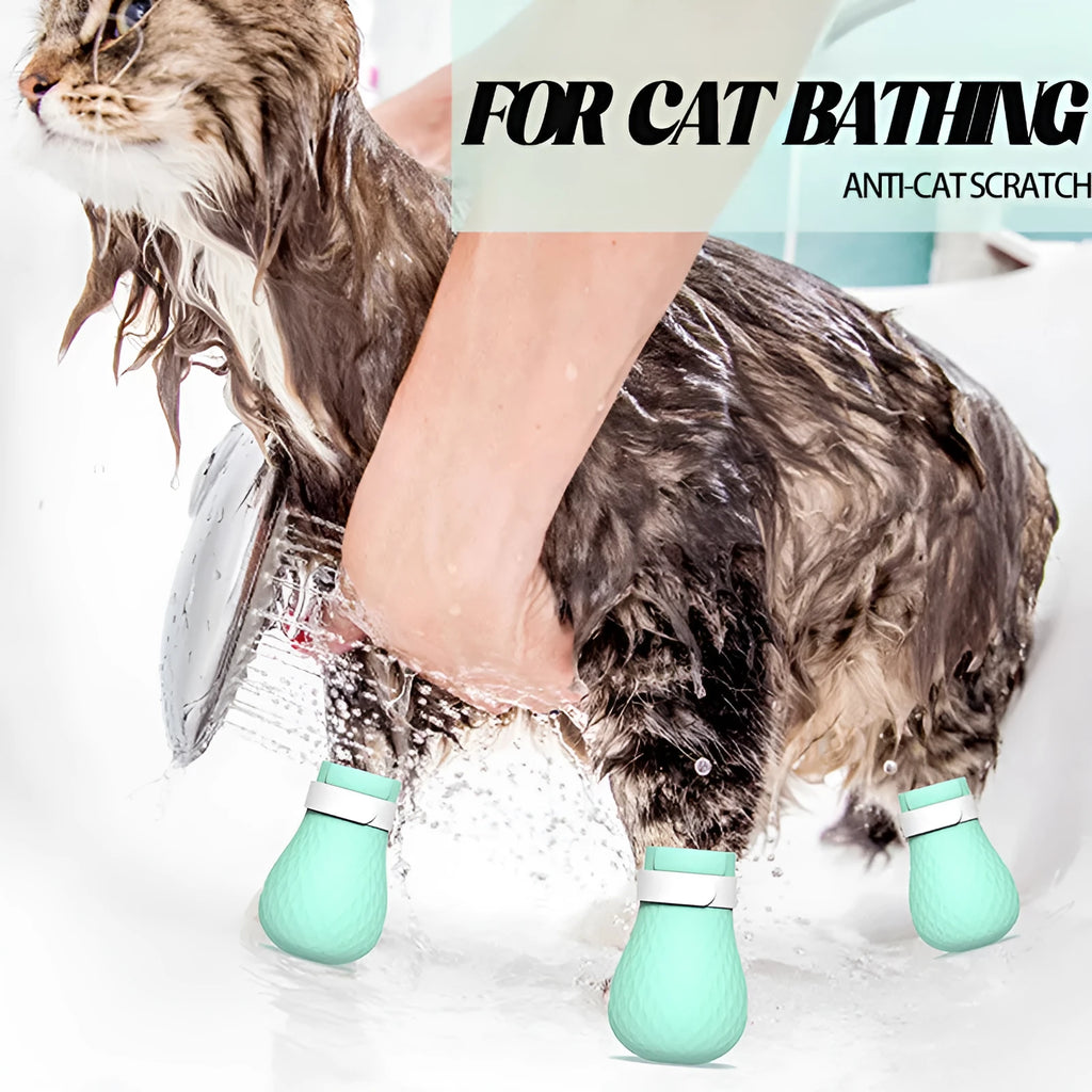 Set of four green silicone cat anti-scratch foot covers or gloves for pet care.