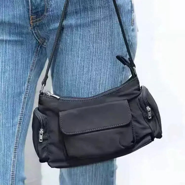 Black nylon lightweight shoulder bag with double pockets showing side line design detail