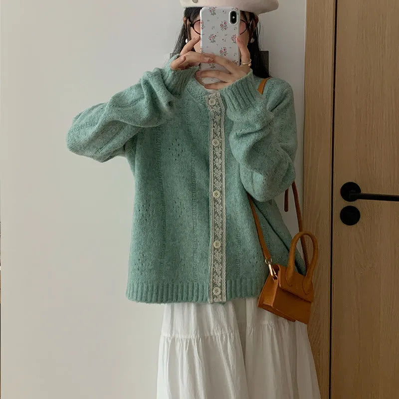 Retro style loose-fit viscose fibre cardigan in apricot colour, shown on a hanger.