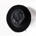 Handmade black wool felt skull hat with conical crown and textured denim-like finish.