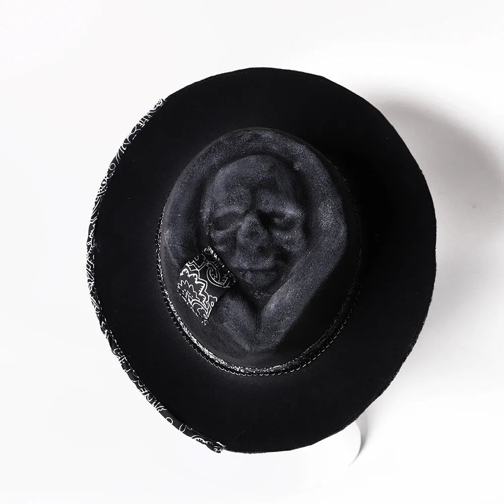 Handmade black wool felt skull hat with conical crown and textured denim-like finish.