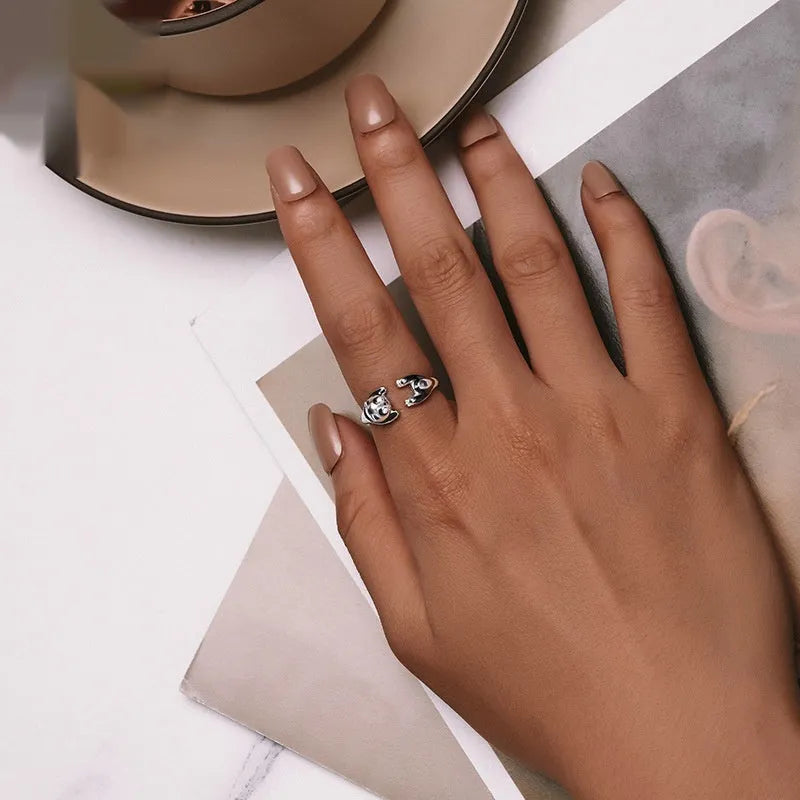 Cute Panda adjustable open ring in sterling silver with white gold plating on a finger.
