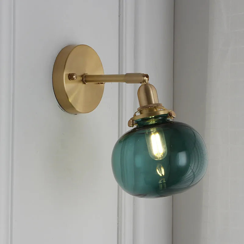 Creative pumpkin-shaped wall lamp with water ripple textured glass shade in blue, mounted on a white wall.