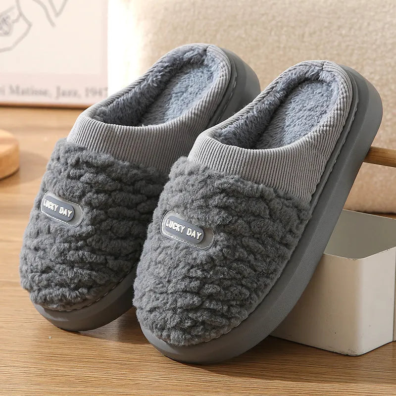 Men's grey and brown plaid winter slippers with a thick sole and rabbit hair trim.