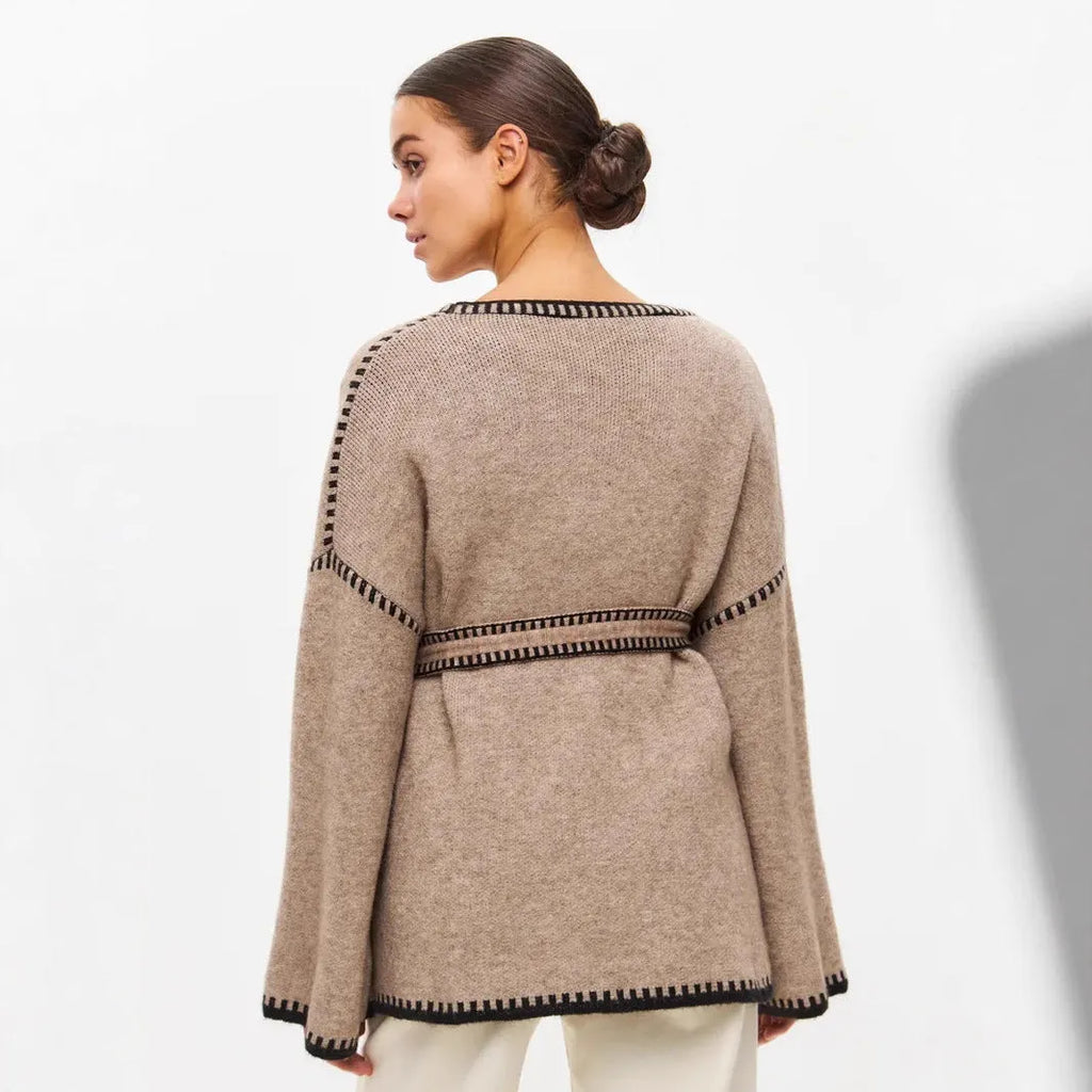 Lace-up front knitted cardigan in black, camel, or white, showing loose fit and thick fabric.