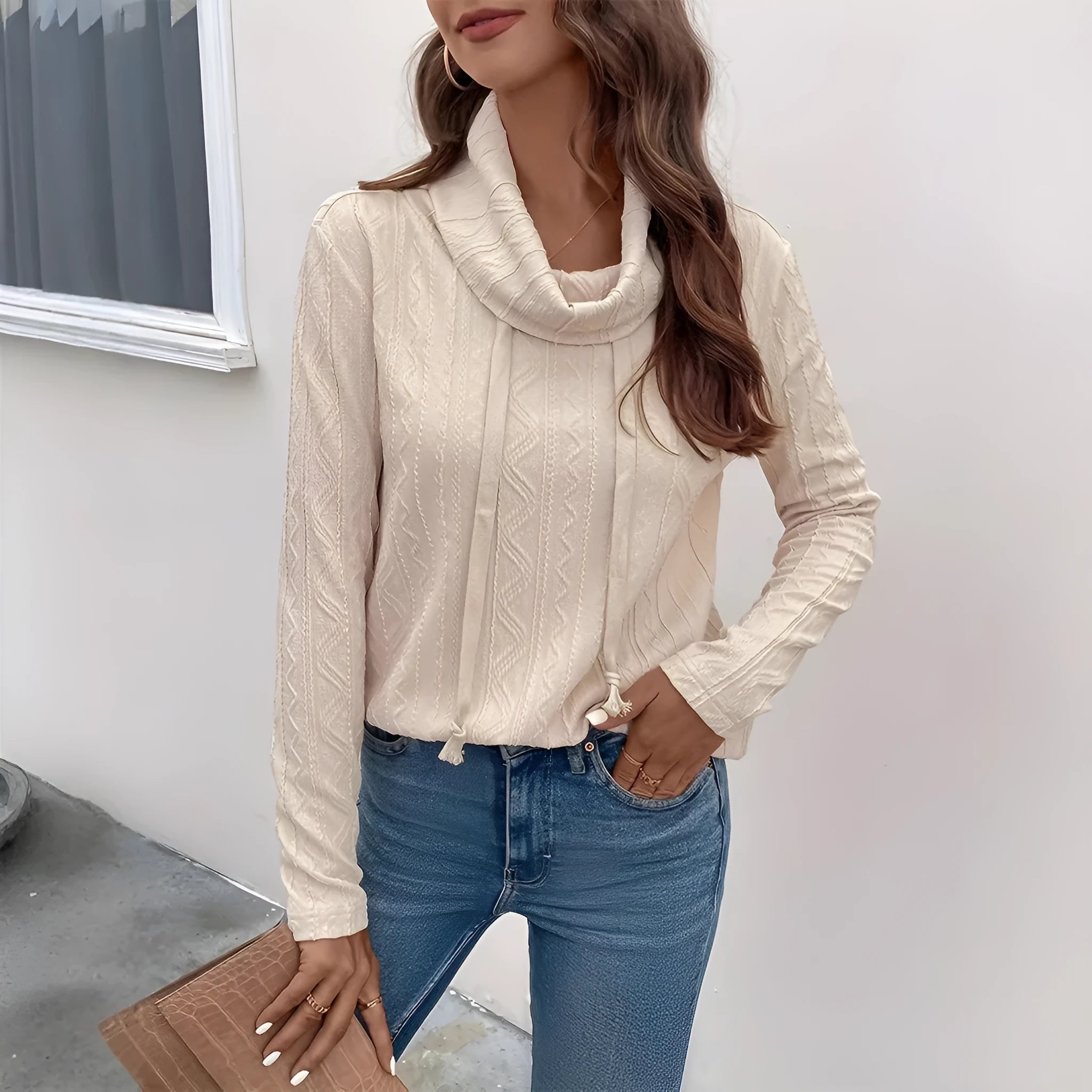 Apricot coloured long sleeve hooded pullover sweater on a hanger.