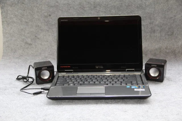 Small black square USB computer speaker model 700B on a desk.