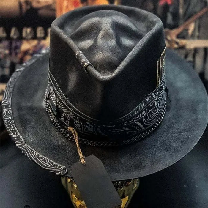 Handmade black wool felt skull hat with conical crown and textured denim-like finish.