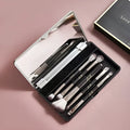 Silver and gold makeup brush sets in a case with a mirror, showing artificial fibre bristles.