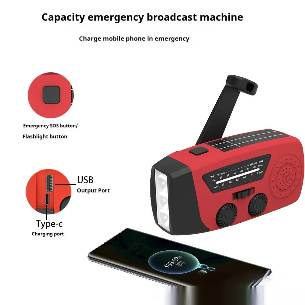 Red rechargeable hand-held emergency radio torch with wrist strap and USB charging port.