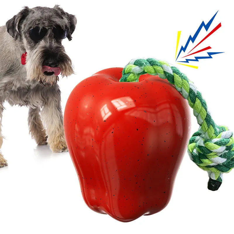 Green and red apple-shaped plastic dog toy with a textured surface and hollow centre.