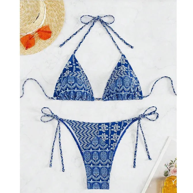 Women's green split bikini swimsuit with bandage-style stitching on a beach.