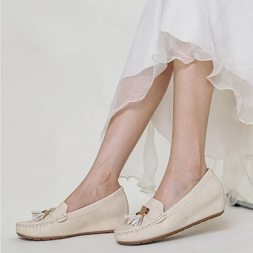 Nude coloured heel lift insoles for women's shoes, showing artificial PU leather upper and round toe shape.