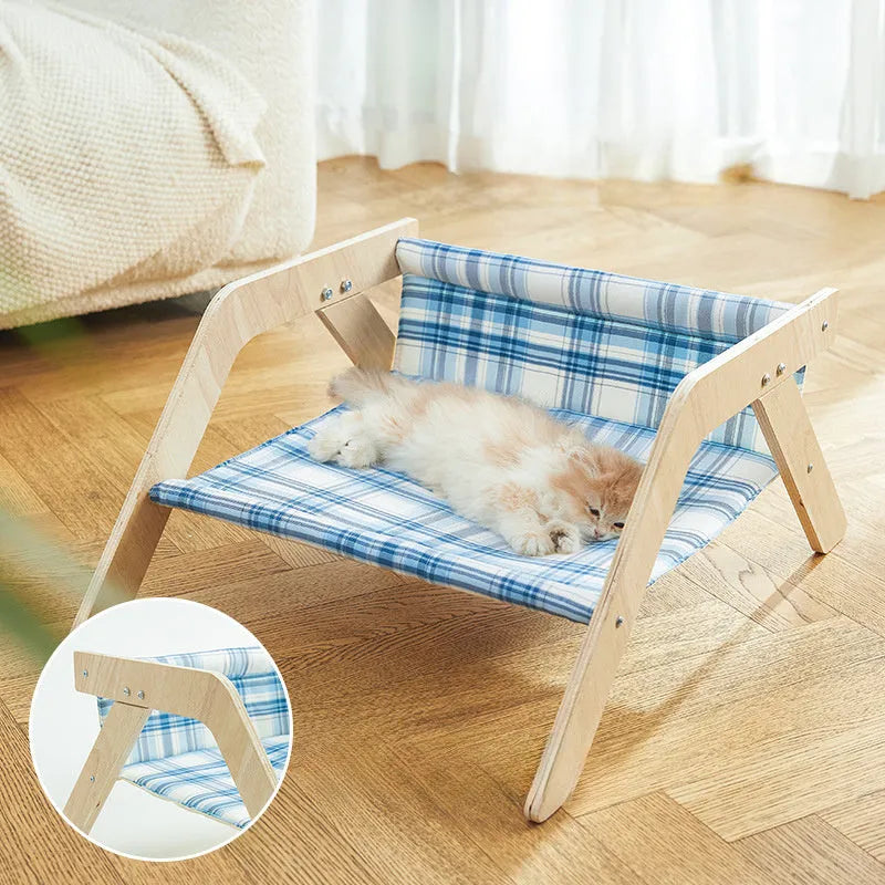 Wooden cat beach chair bed with blue cloth hammock suspended from frame