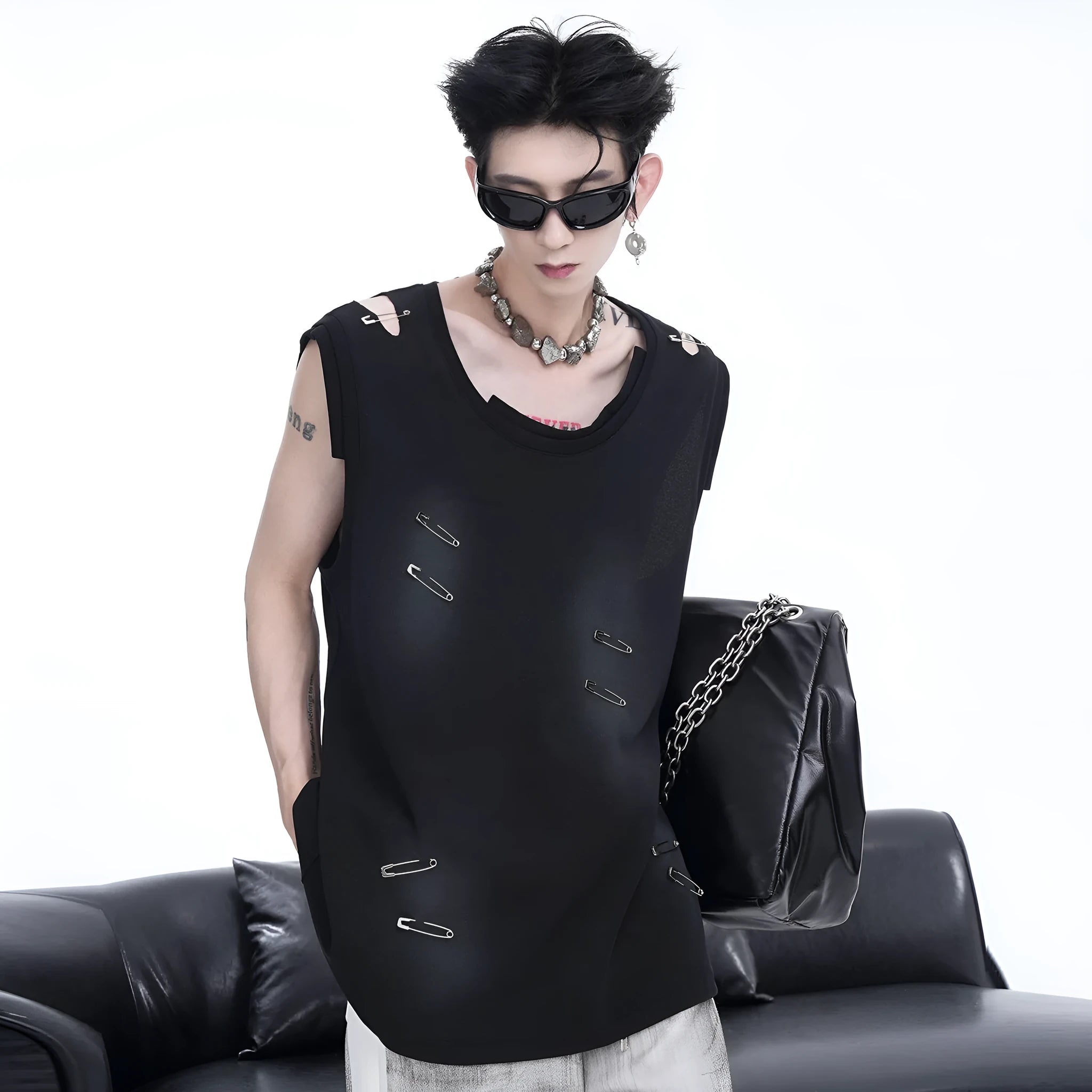 Men's black distressed waistcoat vest with asymmetrical cut on a hanger.