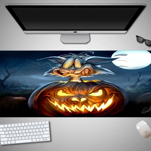 Large Halloween patterned gaming mouse pad on a desk showing non-slip rubber base and extra-long design.