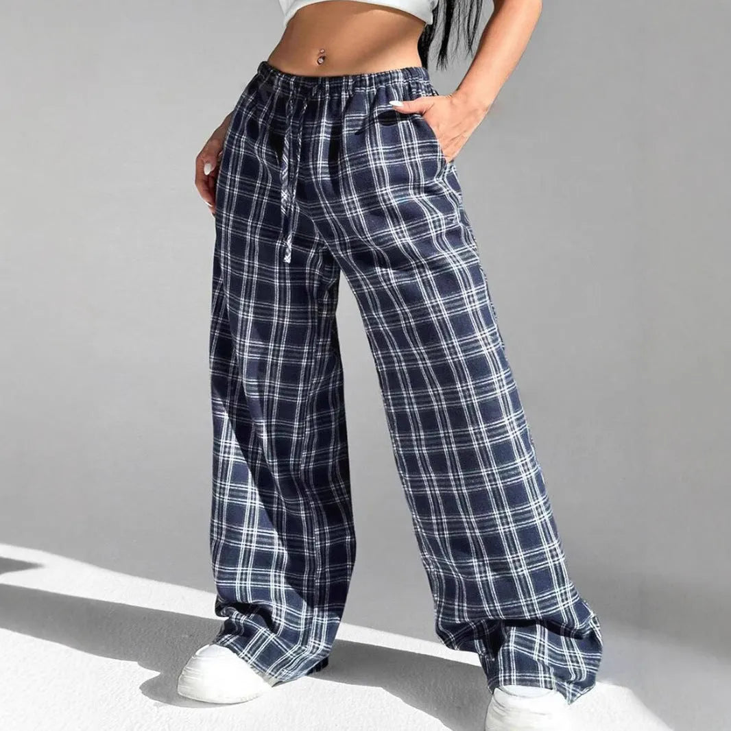 Red plaid women's casual trousers with a drawstring waist and pockets on a hanger.