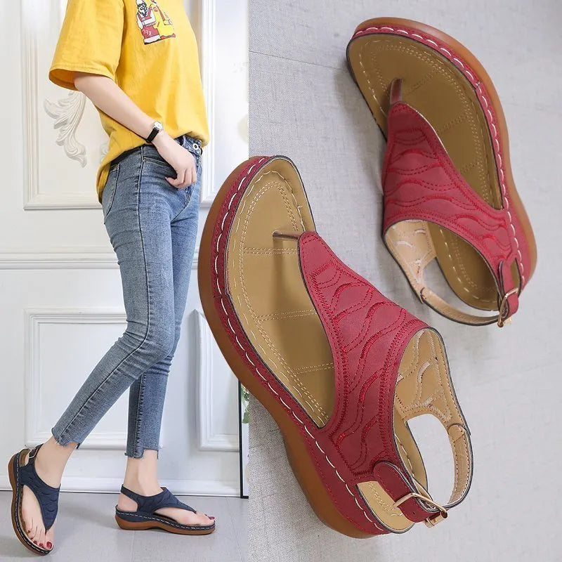 Women's black casual wedge heel flip flop sandals with an adjustable buckle strap.