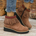 Women's suede wedge ankle boot with tassel detail, side zip, and a thick rubber sole.