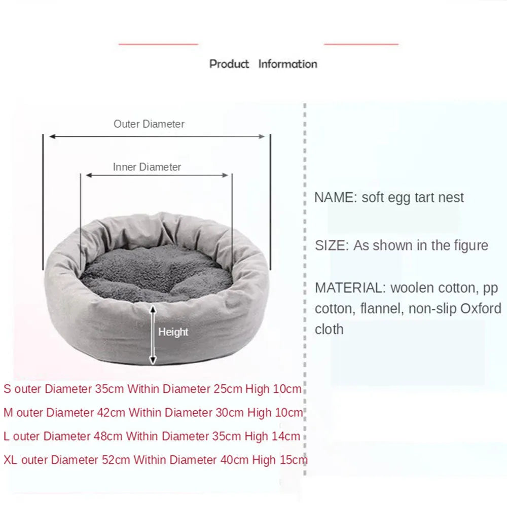 Grey round plush pet bed with raised edge and pillow, shown on a non-slip base.