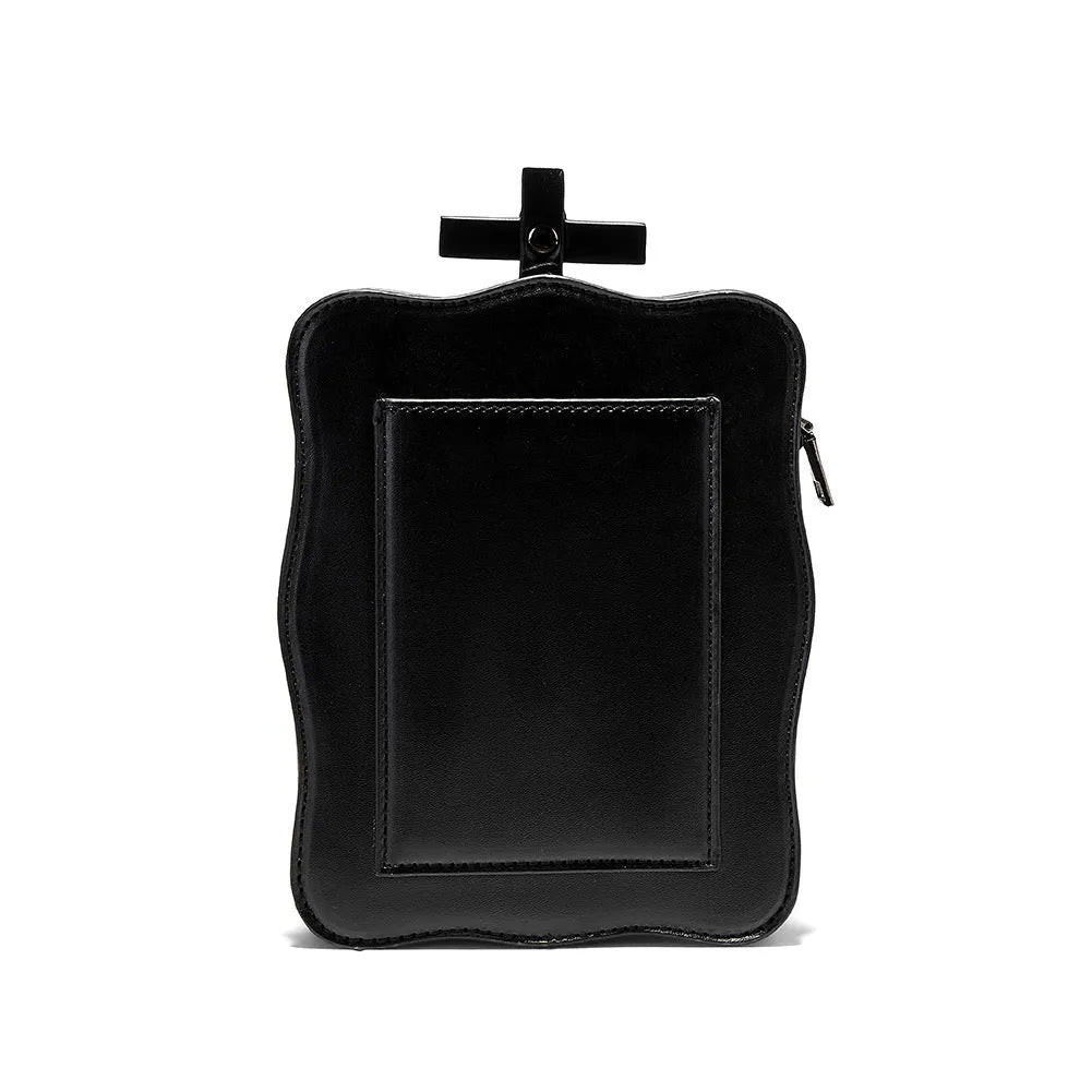 Black mini square crossbody bag with embossed skull design, metal chain strap, and zip opening.