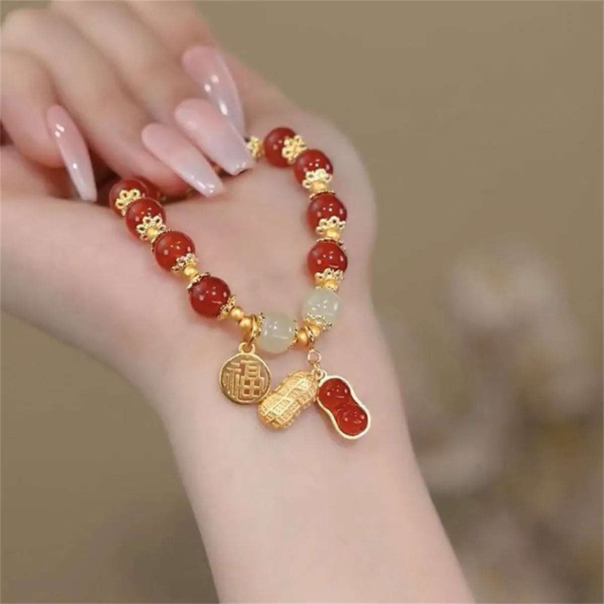 Manual crafted glass and coloured glaze bracelet with rabbit charm and silver peace buckle clasp on wrist.