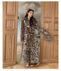 Street fashion faux fur coat with fur collar in mid-length style showing pocket detail