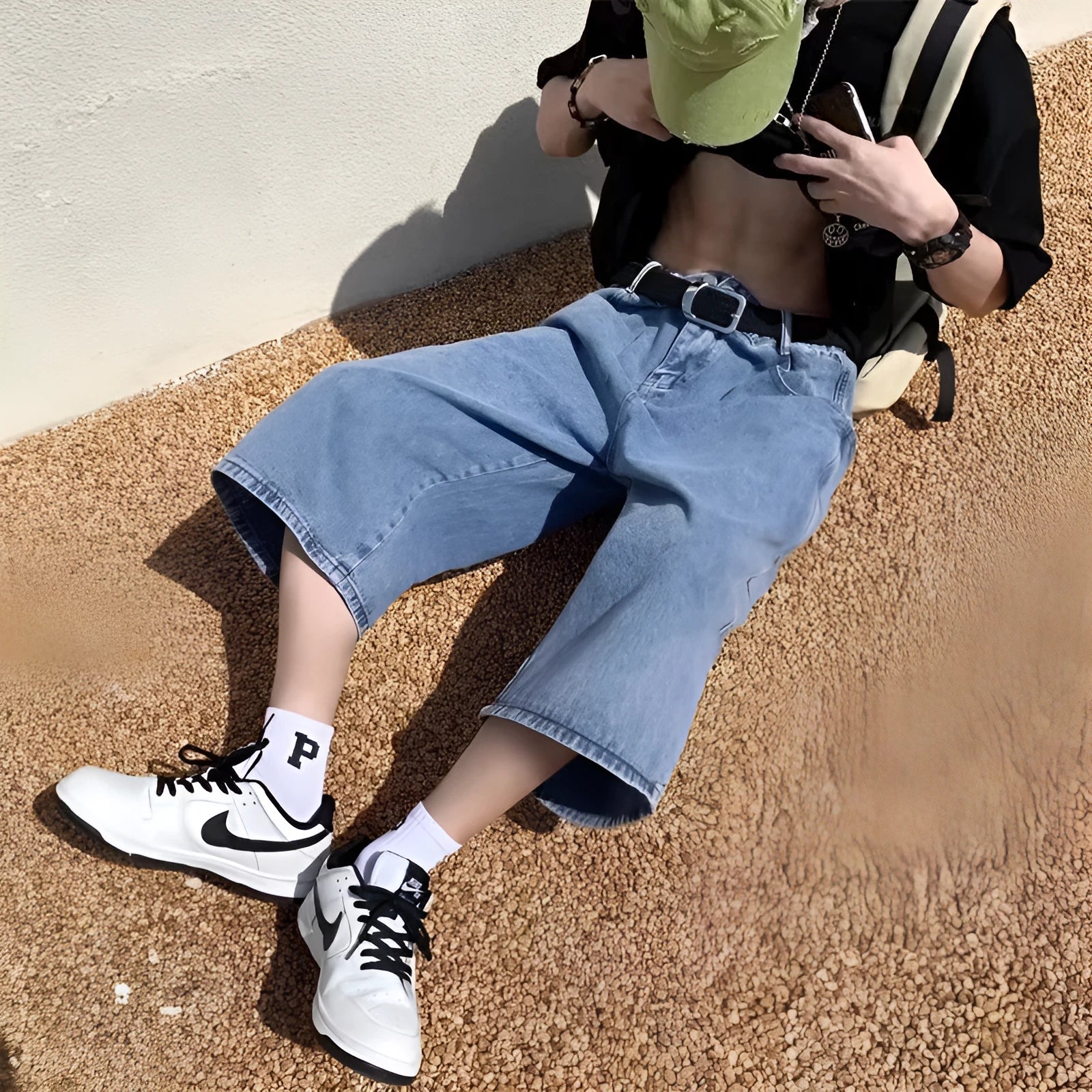 Men's blue washed denim pirate shorts with a high waist, zip fly, and straight cropped legs.